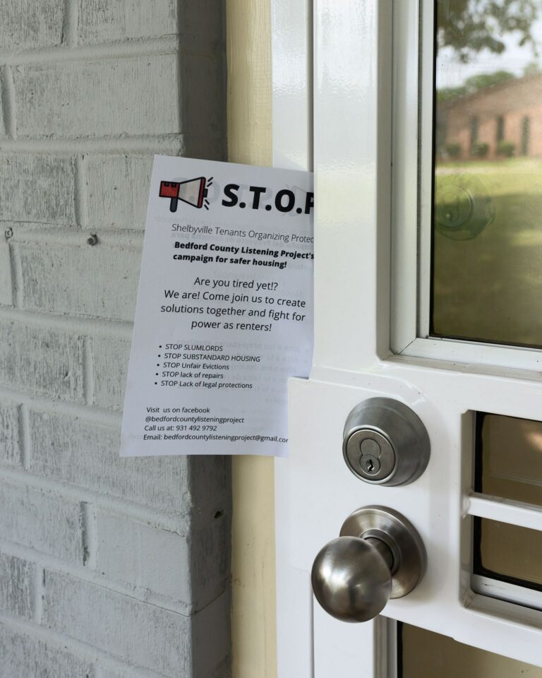 A flyer from the Bedford County Listening Project on a screen door