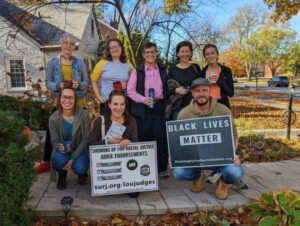 Image of a group of people standing in two lines with signs for Black Lives Matter and Louisville SURJ